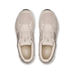 Pair of beige running shoes on a white background