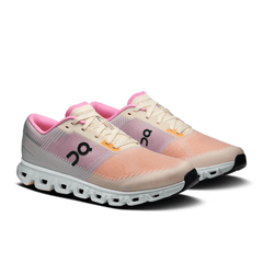 Pair of pink and beige running shoes on a white background