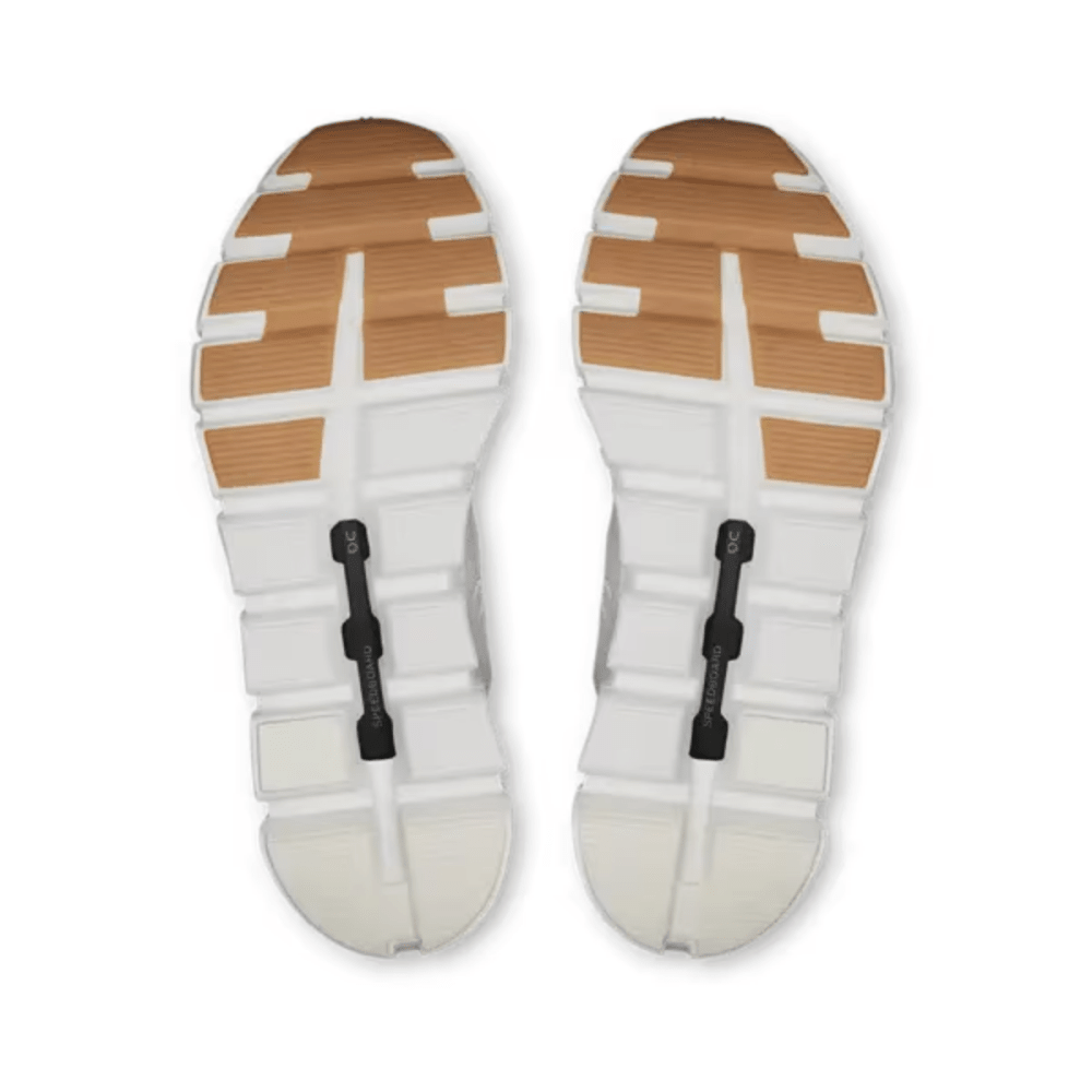 White sandals with brown soles on a white background