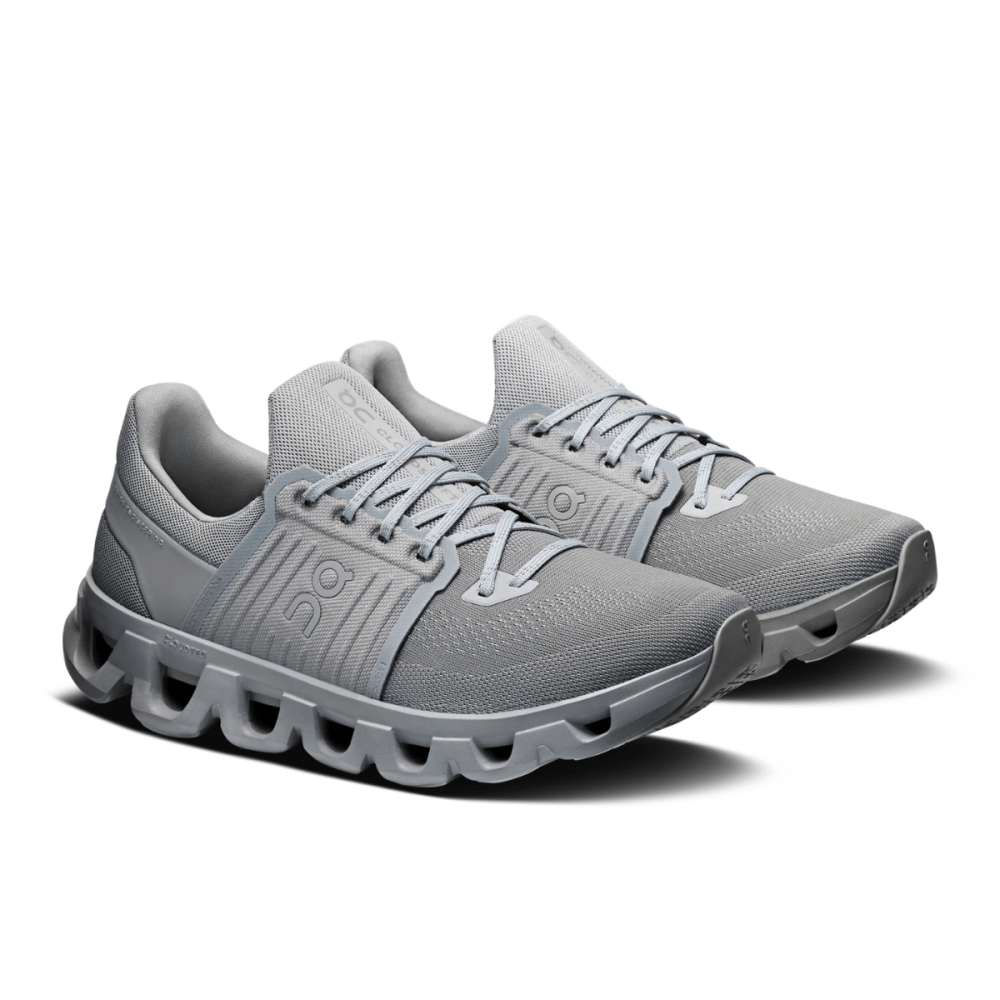Gray running shoes with unique sole design on a white background