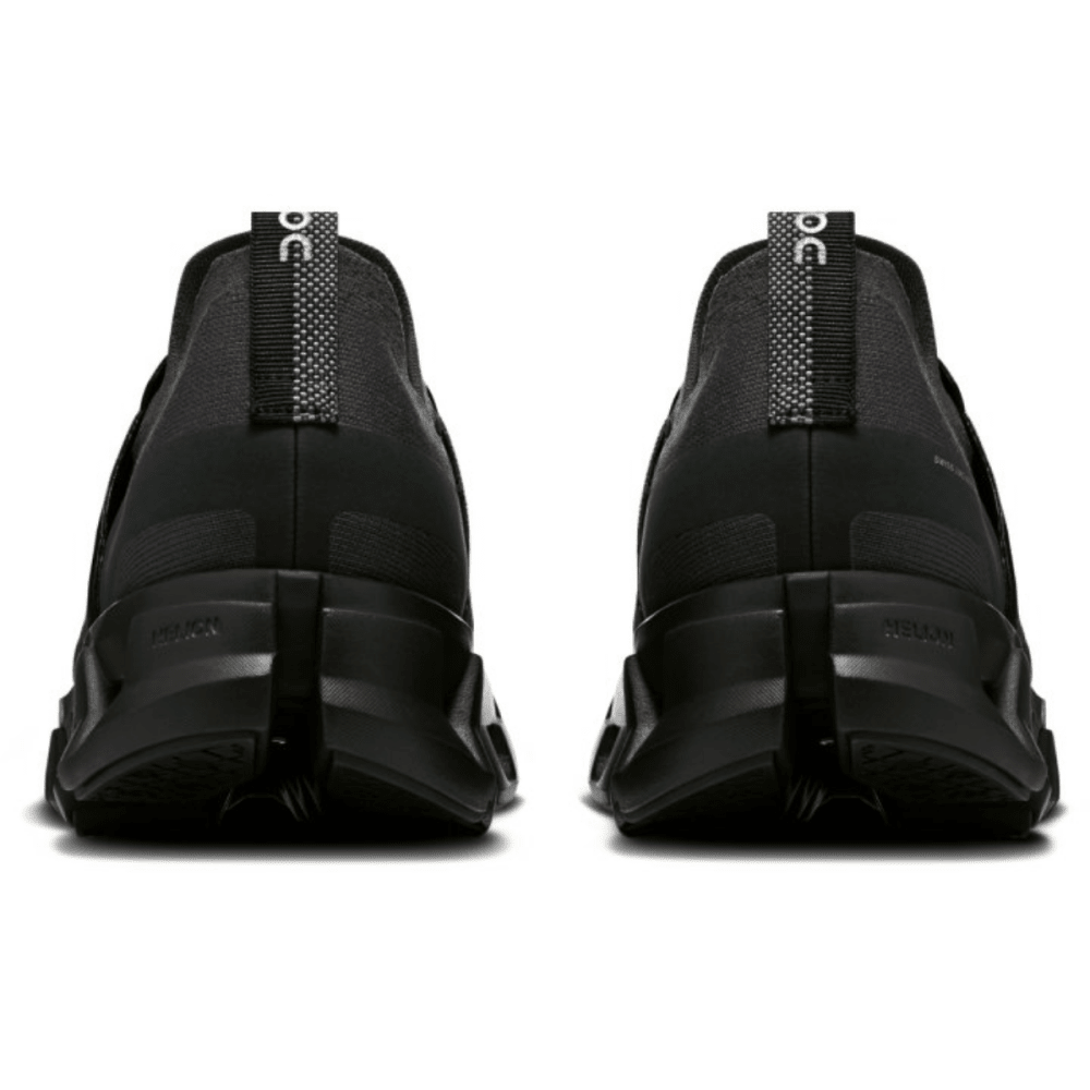 Black slip-on shoes with brand logo on a white background