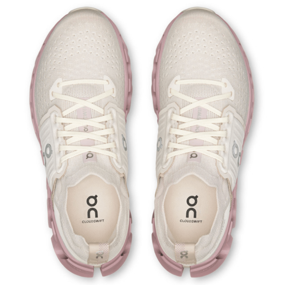White and pink athletic shoes with visible brand logo on a white background
